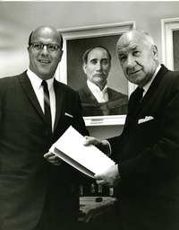 President Darrell Holmes and Dr. William Ross pose in front of a portrait of President Zachariah Xenophon Snyder