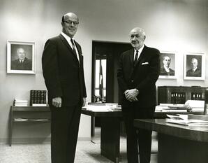 President Darrell Holmes and Dr. William Ross pose together in an office