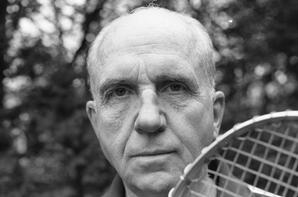 Portrait of James A. Michener with a tennis racket, ca.1975