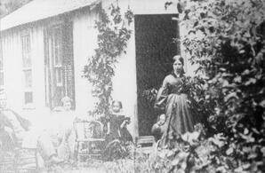 Mrs. Fountain outside home, ca. late 1800s
