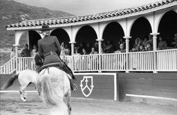 James A. Michener watching Budd Boetticher, and his wife Mary, perform on horseback, ca. 1975