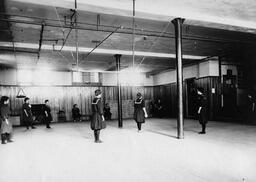 Women playing softball in Cranford Hall gymnasium, State Normal School