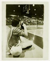 Photographer at University of Northern Colorado basketball game, 1982.