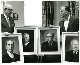 President William Ross and Richard Ellinger holding portraits of past presidents