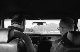 James A. Michener sits in the passenger seat of an automobile, next to Budd Boetticher, ca. 1975