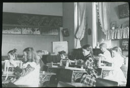 [Children weaving in a classroom]