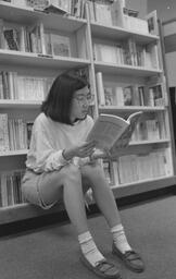 Student reading in the University Center bookstore, May 1992
