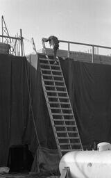 Worker descends a ladder at the construction site of the University Library, early 1970s