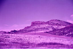 Butte overlooking snow-covered prairie