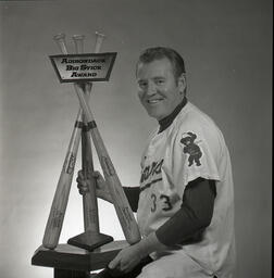 University of Northern Colorado baseball coach, Tom Petroff, poses with the Adirondack Big Stick Award, 1972