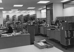 Library staff prepare books for the collection in the James A. Michener Library, ca. 1970s