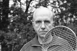 James A. Michener with tennis racket, 1975