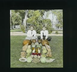 [Two Children Displaying Vegetables]