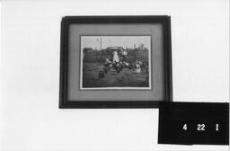 Framed photograph showing three people in chicken run, Dearfield, Colorado, ca. 1910s